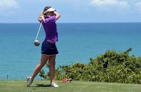 lady golfer takes a swing